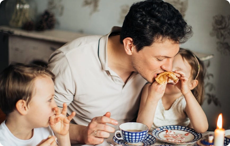 A father sharing a meal with his two children